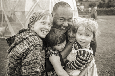 Lama Yeshe with children, Festival Day at Manjushri Institute, 1979. Photo: Brian Beresford.