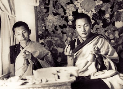 Lama Zopa Rinpoche and Lama Yeshe doing puja (spiritual practice) in the &quot;old gompa&quot; (shrine room), Kopan Monastery, 1970.