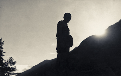 Lama Zopa Rinpoche on the mountainside, Lawudo Retreat Centre, Nepal, 1973. Photo: Nick Ribush.