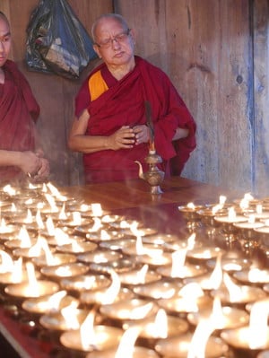 Lama Zopa Rinpoche offering butter lamps at Kyichu Lhakhang, a temple in Bhutan.  Photo: Roger Kunsang. 