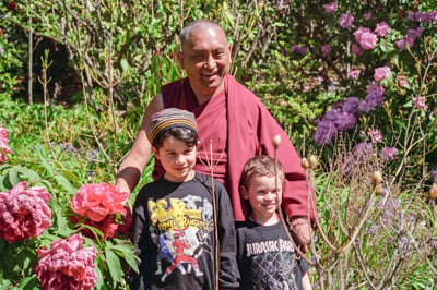 Lama Zopa Rinpoche with children at Chenrezig Institute, Australia, 1994. 