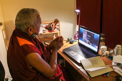 Lama Zopa Rinpoche giving bodhisattva vows over Skype to a student with ALS. 
