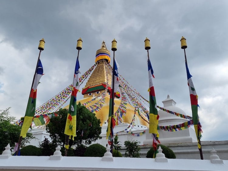 Boudha Stupa with fresh saffron and prayer flags offered on Chokhor Duchen, Kathmandu, Nepal, July 2023. Photo: Sandy Smith.