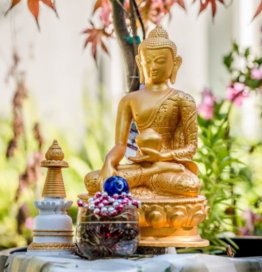 Shakyamuni Buddha statue with offerings on Saka Dawa, Kachoe Dechen Ling, CA, June 2017.