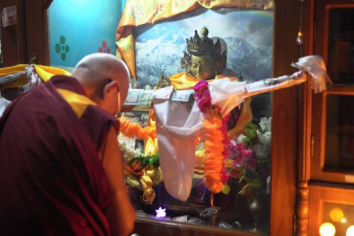 Rinpoche making prayers in front of the Maitreya statue that speaks at Jampaling Tibetan settlement in Pokhara, Nepal, 2018. Photo:Lobsang Sherab.