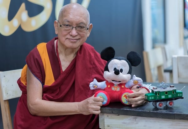Rinpoche with gifts he bought for Osel's son