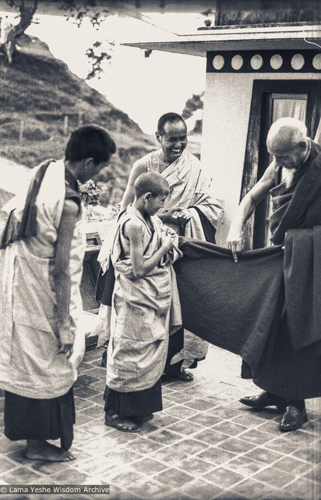 (08570_ng-3.JPG) Zong Rinpoche shows Losang Tseten how to wear a zen as Lama Yeshe and Lama Zopa Rinpoche look on, Kopan Monastery, 1974.