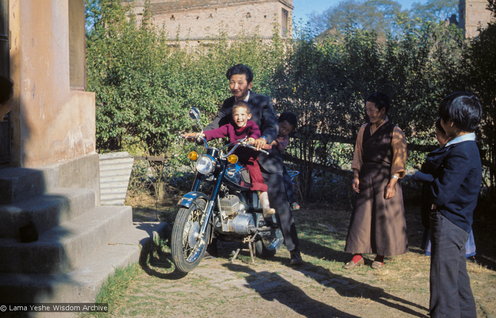 (09619_sl.JPG) Jampa Trinley and Daja Meston (Thubten Wangchuk) on a motor cycle, at their house in Kathmandu, Nepal, 1975. Kelsang Puntsog Rinpoche, the son of Lama Yeshe&#039;s old friend Jampa Trinley, was later recognized to be the reincarnation of Geshe Ngawang Gendun, one of Lama&#039;s teachers.