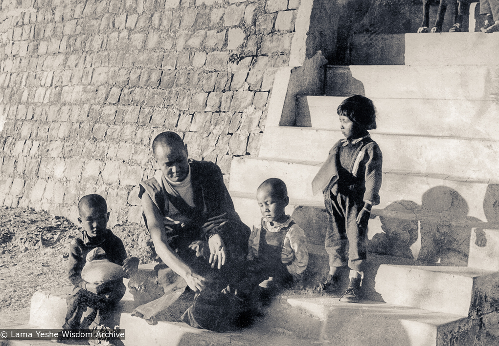 (11715_ud-3.psd) Lama Yeshe with Jhamba Drolkar (Lama&#039;s &quot;daughter&quot; at TCV) and two Nepalese boys on the front steps of Tibetan Children&#039;s Village, Dharamsala, India, 1973.