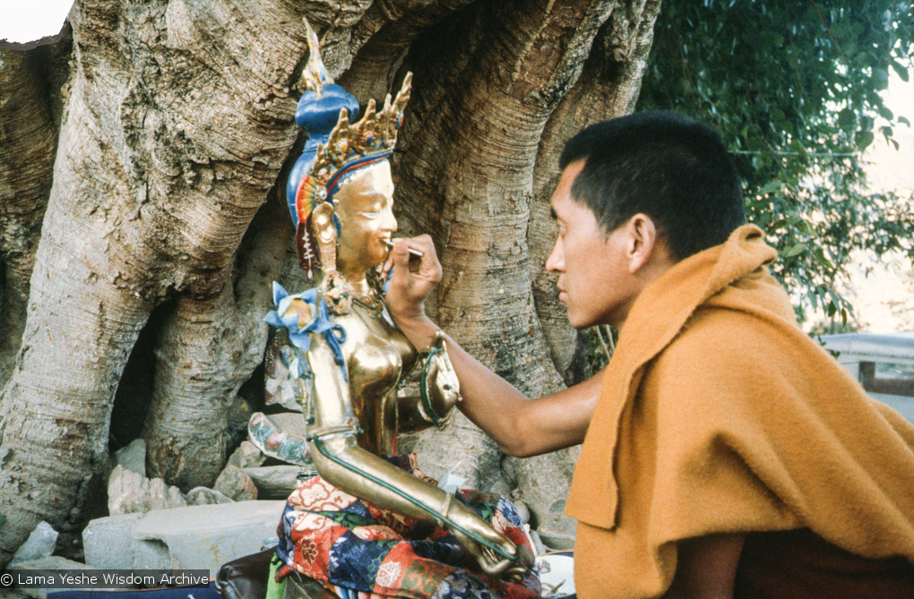 (12926_sl.tif) Lama Zopa Rinpoche painting Tara, Kopan Monastery, Nepal, 1976. Lama Yeshe sent Max Mathews to buy a large Tara statue in Kathmandu, which was eventually placed in a glass-fronted house on a pedestal overlooking a triangular pond that was built under the ancient bodhi tree in front of the gompa, Kopan Monastery, Nepal. Photo by Peter Iseli.
