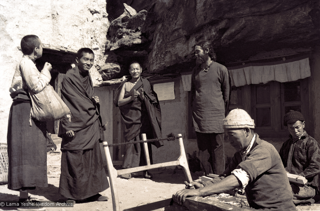 (15077_ng-1.psd) From the left: Tsultrim Allione, Lama Zopa Rinpoche, Lama Yeshe and Robert Sternfield with workers outside of the cave of the Lawudo Lama, Lawudo Retreat Centre, 1970. Photo by Terry Clifford.