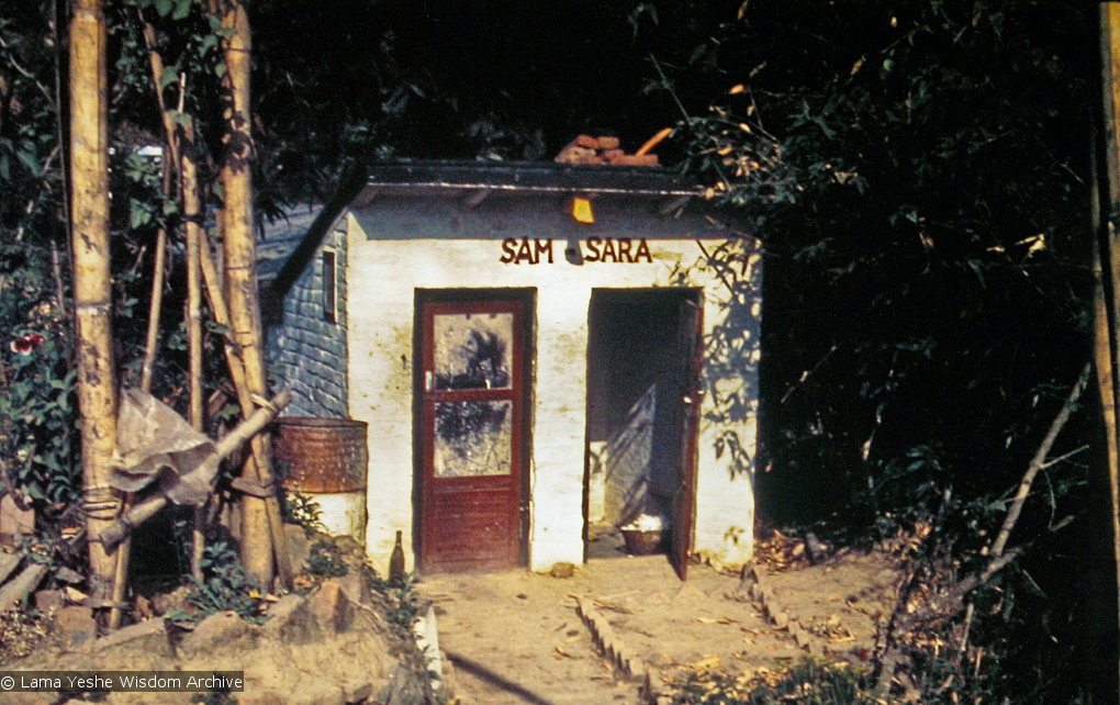 (15187_pr.psd) The outhouse labeled Sam-Sara at Kopan Monastery, Nepal, 1973. A pun on the sanskrit term &quot;samsara&quot; which refers to the beginningless, recurring cycle of death and rebirth fraught with suffering. Photo by Lynda Millspaugh.