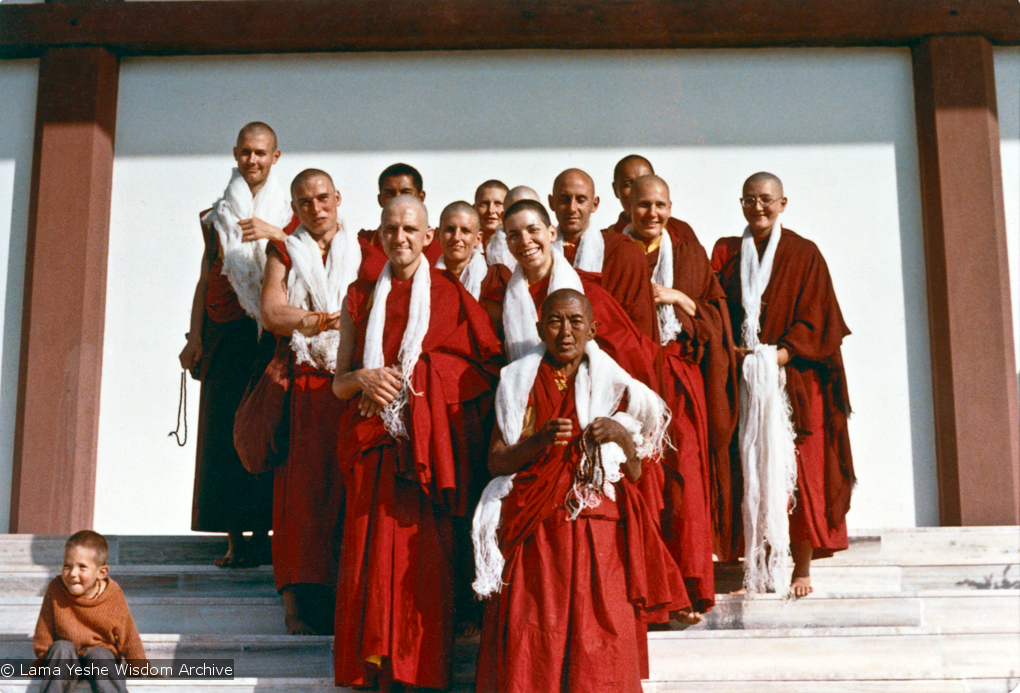 (15469_ud.psd) Ordination photo of western Dharma students including Gareth Sparham, Marcel Bertels, Ama-la (Mother of Lama Zopa), Nick Ribush, Nicole Couture, Thubten Pemo (Linda Grossman), Thubten Pende (Jim Dougherty), Ursula Bernis, Thubten Wongmo  (Feather Meston), Yeshe Khadro (Marie Obst) and Daja Meston (Thubten Wangchuk), son of Wongmo, on the steps to the left. It is interesting to note that Lama Yeshe and Lama Zopa Rinpoche are both in the photo, but hiding behind the heads of the new monastics. Bodhgaya, India, 1974.