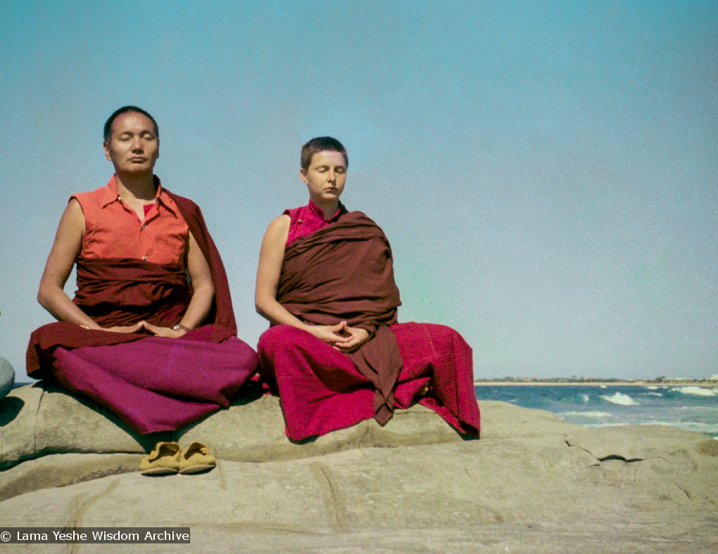(15850_ng.tif) Lama and Yeshe Khadro meditating by the ocean, Maroochydore, Australia, 1974. The lamas took a day off during the Diamond Valley course to go to the beach in Tom Vichta&#039;s van. Everyone got out to enjoy the view from the cliffs, but Lama Yeshe ran straight down to the water&#039;s edge, hitched up his robes, and waded in, splashing about with delight.