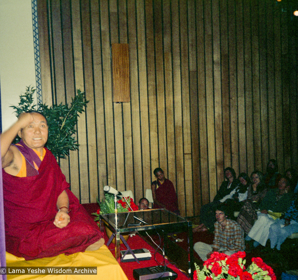 (15973_ng.tif) Lama Yeshe giving a public talk, Adyar Theater, Sydney, Australia, 8th of April, 1975.  Lama Zopa Rinpoche can be seen sitting by the wall.