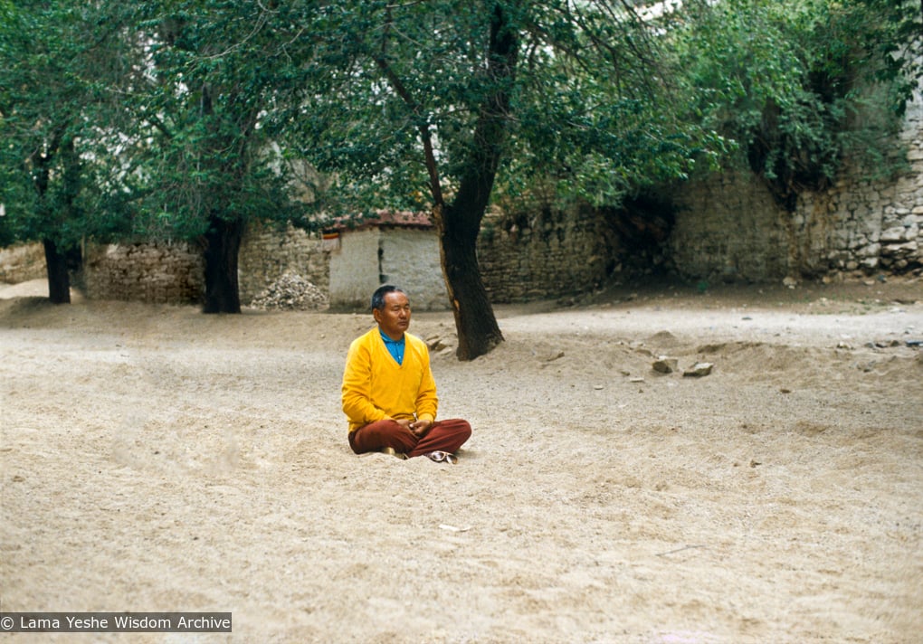 Lama Yeshe meditating at the site of his old room, Sera Monastery, Tibet, 1982.