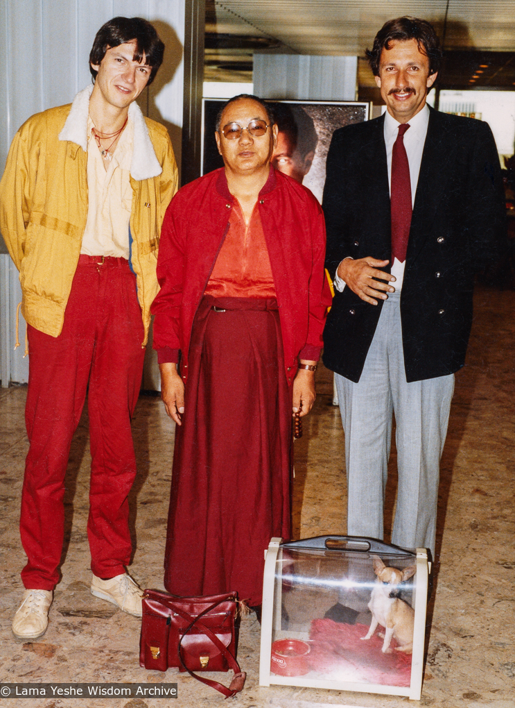(21993_pr-6.psd) Lama Yeshe at airport with Lama the chuhuahua, Jean Pascal Moret on left and Philippe Pruneta in Vajra Guard uniform, Pisa, Italy, 1982