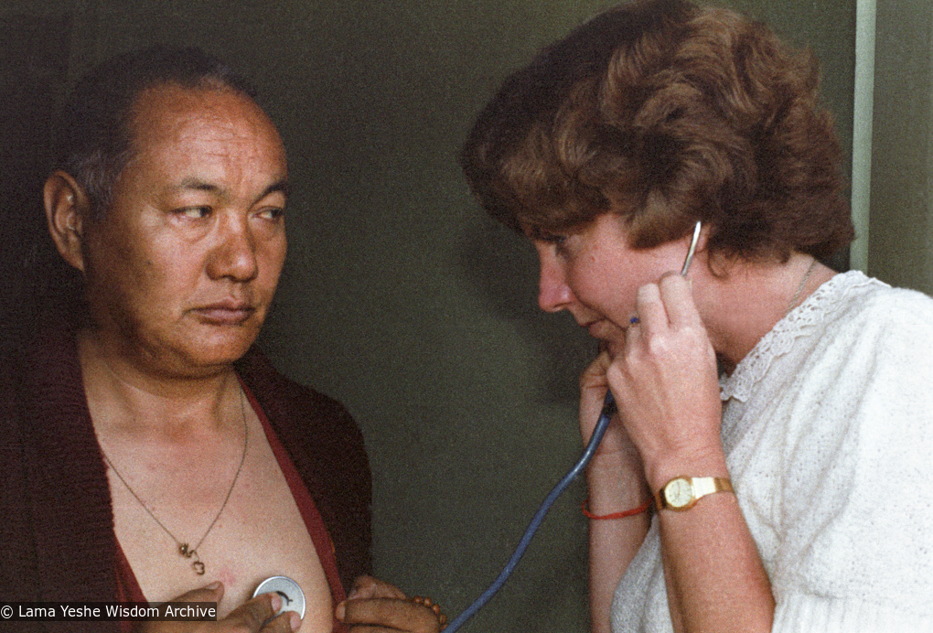 (23036_ng-3.psd) Jacie Keeley listening to Lama Yeshe&#039;s heart, Bodhgaya, India, 1982.