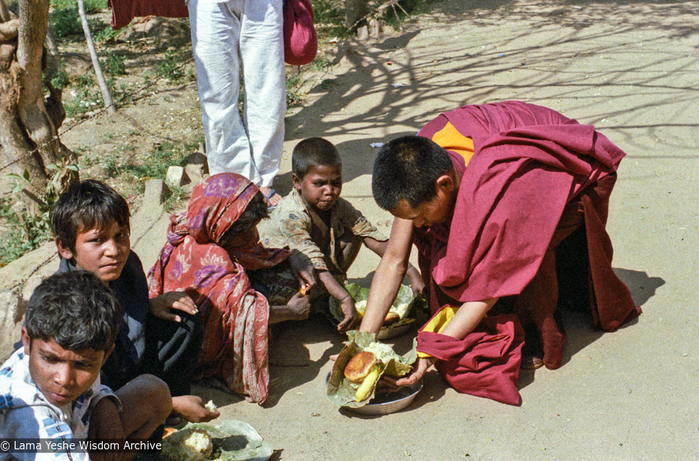 (23255_ng-3.psd) Beggars&#039; banquet, Bodhgaya, India, 1982. Lama Zopa Rinpoche feeding people on the street.