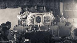 (15159_ng.psd) 1972, installing the portrait of His Holiness the Dalai Lama in the Kopan Gompa. Lama Yeshe and Lama Zopa with other monks offering prayers.