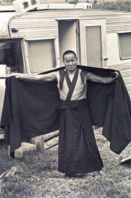 Lama adjusts his robe, 1975