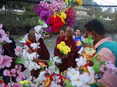 Lama Zopa Rinpoche shops for flower offerings with Pemba, at Swambunath, Nepal, February 2016. Photo: Holly Ansett. 