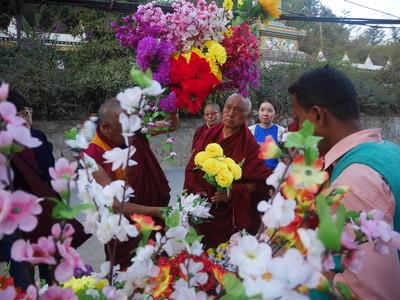 Lama Zopa Rinpoche shops for flower offerings with Pemba, at Swambunath, Nepal, February 2016. Photo: Holly Ansett.