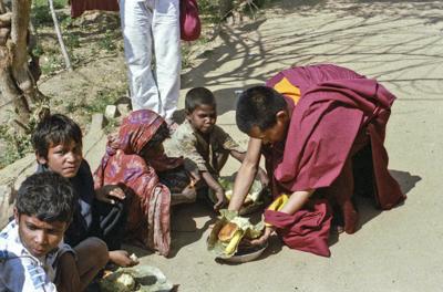 Beggars&#039; banquet, Bodhgaya, India, 1982. Lama Zopa Rinpoche feeding people on the street. 