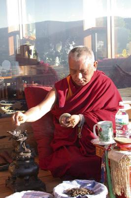 Lama Zopa Rinpoche making offerings to Dorje Khadro, a deity associated with purification.