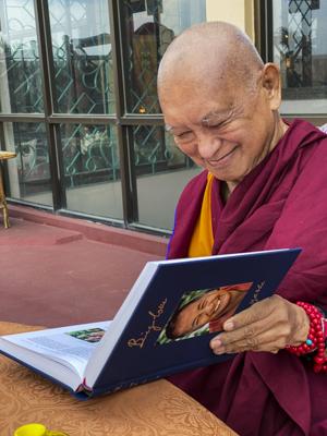 Lama Zopa Rinpoche enjoying his copy of Big Love, Kopan Monastery, Nepal, April 2020. Photo: Ven. Roger Kunsang.