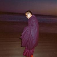Lama Zopa Rinpoche at the beach, 1983