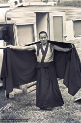 Lama adjusts his robe, 1975